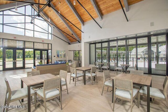 107 Freedom Park Rd, Beaufort, NC 28516 - dining space featuring high vaulted ceiling, french doors, wood ceiling with exposed beams, and wood finished floors