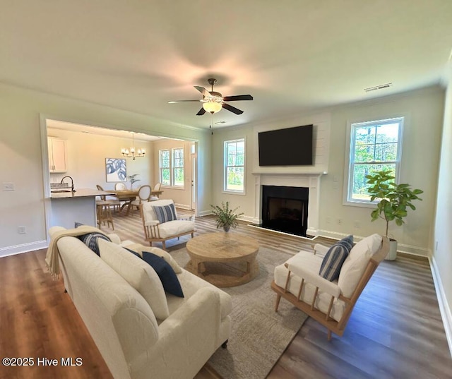 107 Freedom Park Rd, Beaufort, NC 28516 - living area featuring baseboards, dark wood-style flooring, a fireplace with raised hearth, and a ceiling fan