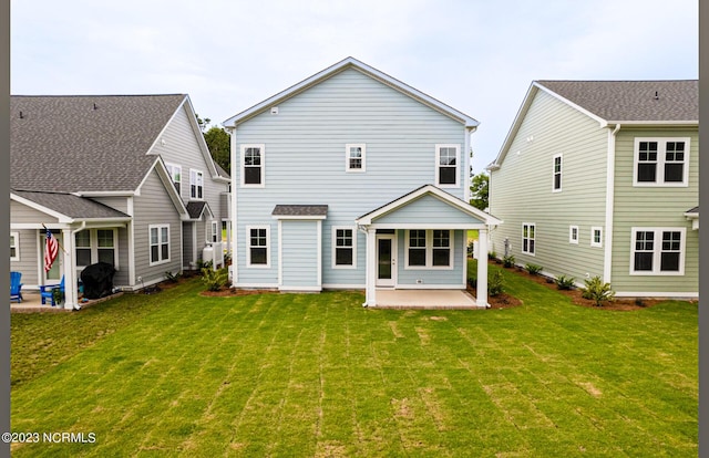 back of property featuring a yard and a patio