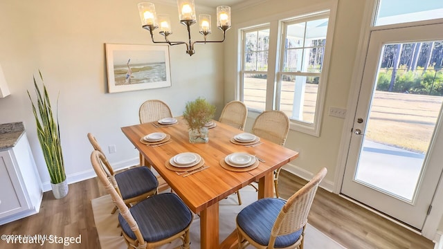 dining space featuring a chandelier and light wood-type flooring