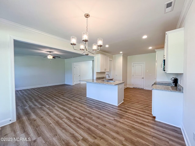 kitchen featuring ceiling fan with notable chandelier, sink, range with electric cooktop, decorative light fixtures, and white cabinetry