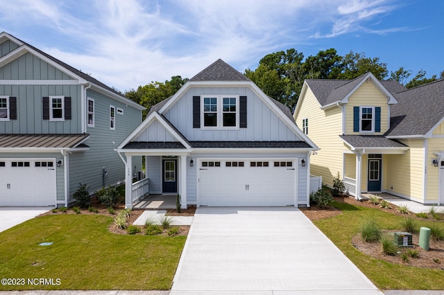 view of front of property featuring a garage, covered porch, and a front lawn