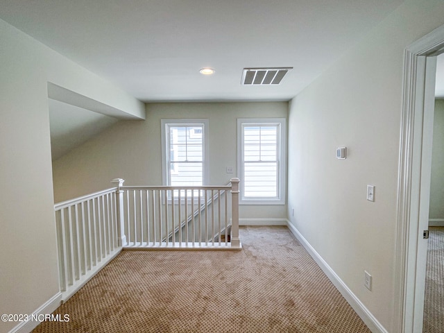 hallway with light colored carpet