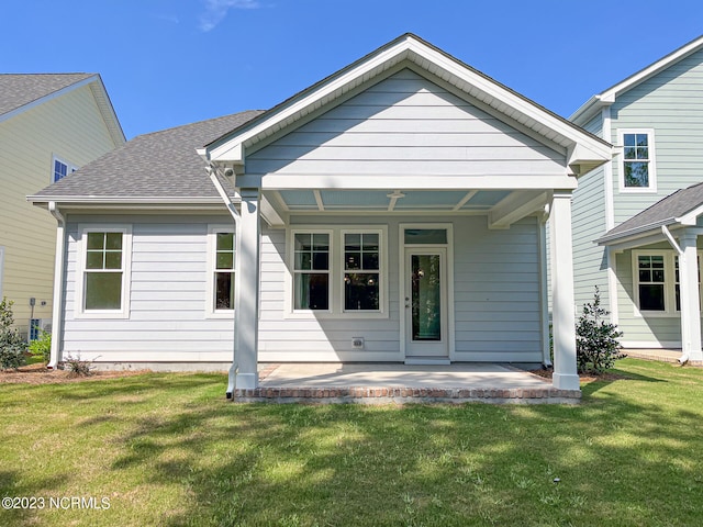 rear view of house with a lawn