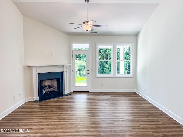 unfurnished living room featuring ceiling fan and hardwood / wood-style flooring