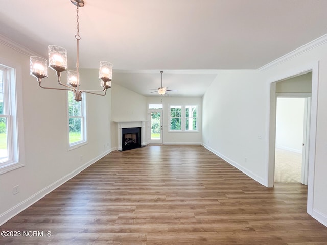 unfurnished living room with vaulted ceiling, wood-type flooring, ornamental molding, and ceiling fan with notable chandelier