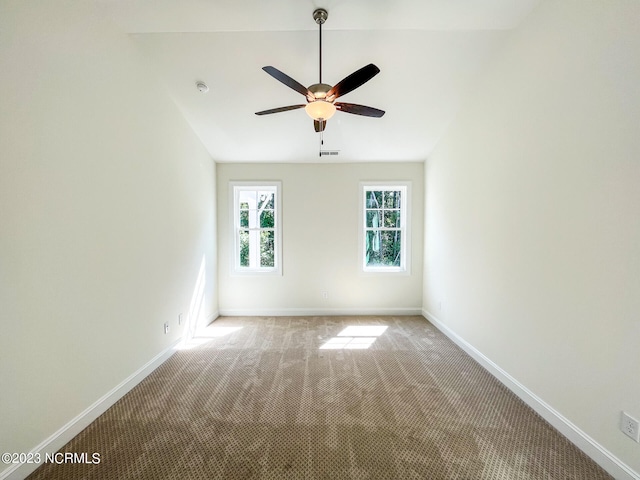 carpeted empty room with ceiling fan and vaulted ceiling