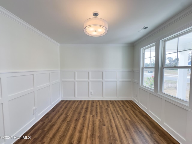 empty room featuring dark hardwood / wood-style floors and ornamental molding