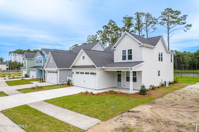 view of front of house featuring a front lawn, a porch, and a garage