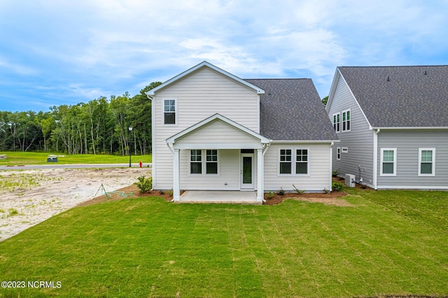 back of house featuring a lawn