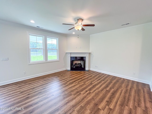 unfurnished living room featuring crown molding, ceiling fan, and dark hardwood / wood-style floors