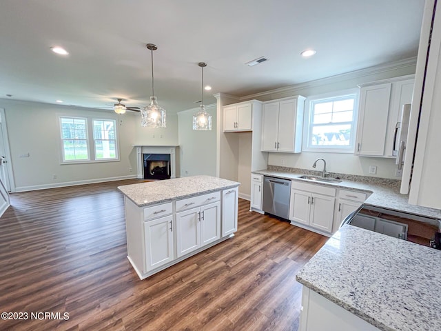 kitchen featuring white cabinets, dishwasher, a center island, and sink