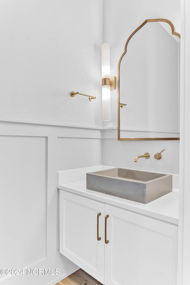 bathroom with vanity and hardwood / wood-style flooring