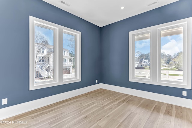 spare room with light hardwood / wood-style flooring