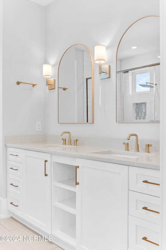 bathroom with vanity, tile patterned flooring, and a shower with door