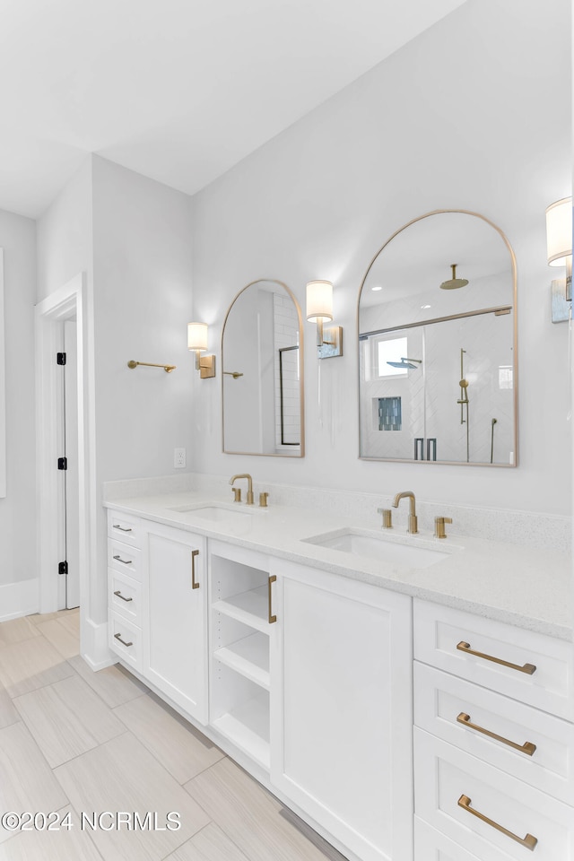 bathroom with vanity, a shower with shower door, and tile patterned floors