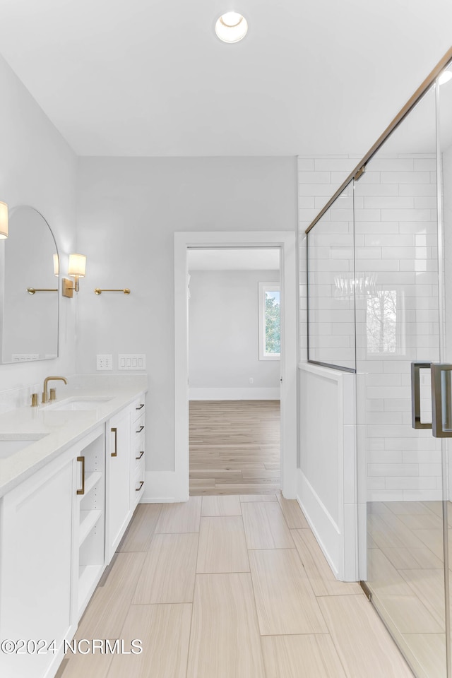 bathroom featuring vanity, a shower with shower door, and hardwood / wood-style floors