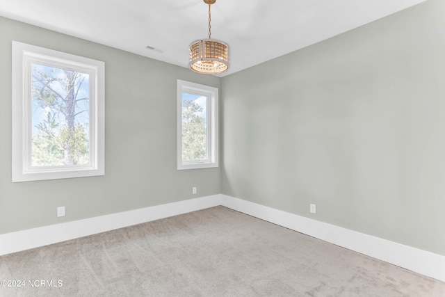 carpeted empty room with a healthy amount of sunlight