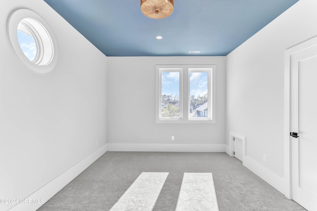 additional living space featuring light colored carpet