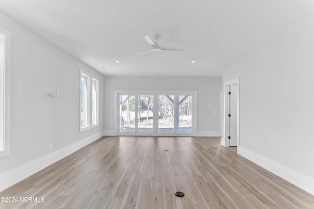 unfurnished living room featuring ceiling fan and light hardwood / wood-style flooring