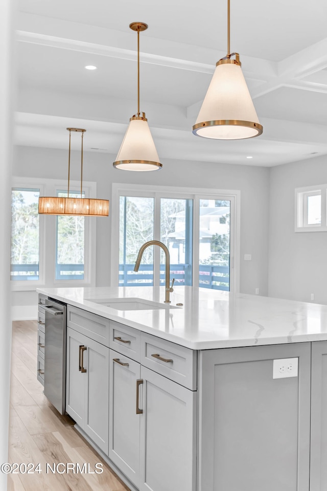 kitchen with gray cabinetry, light hardwood / wood-style flooring, sink, and light stone counters