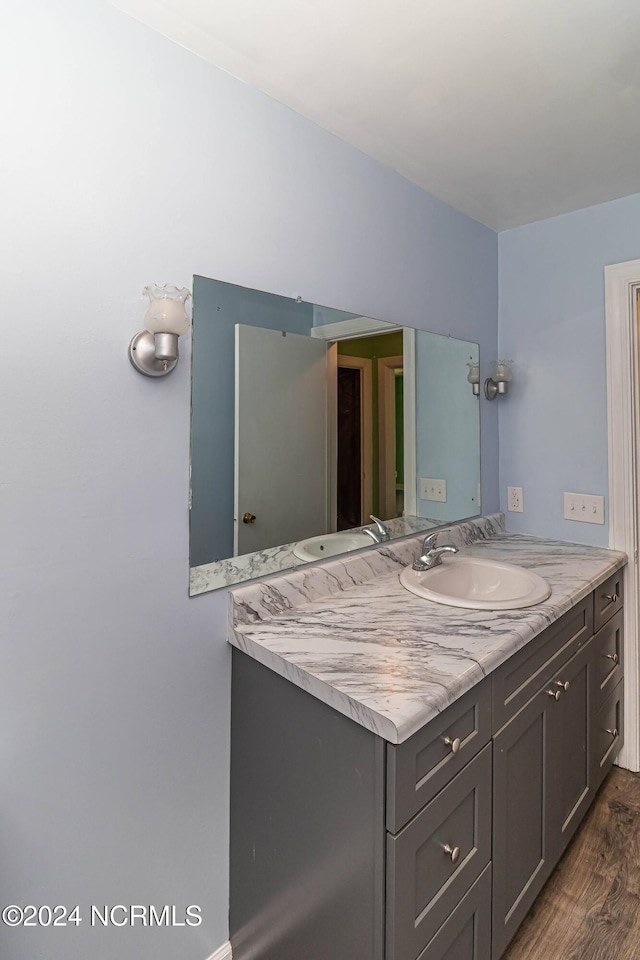 bathroom with vanity and hardwood / wood-style floors