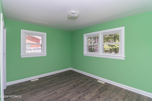 spare room featuring dark hardwood / wood-style floors