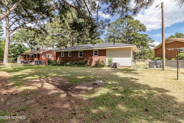 rear view of house featuring a yard