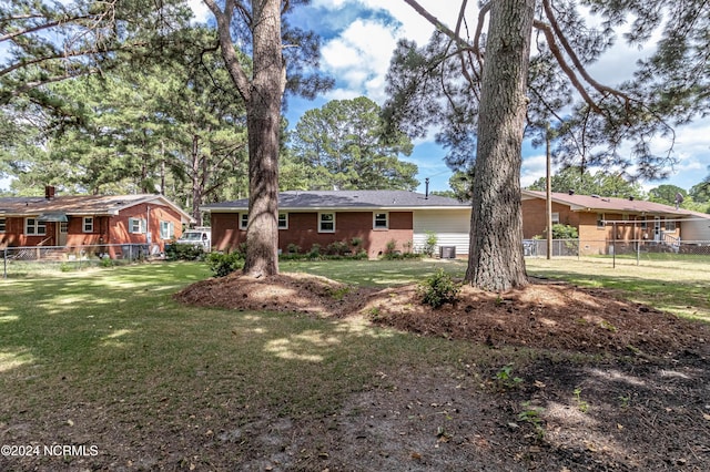 rear view of house featuring a yard