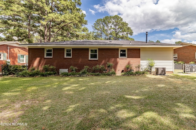 back of house with a lawn and cooling unit