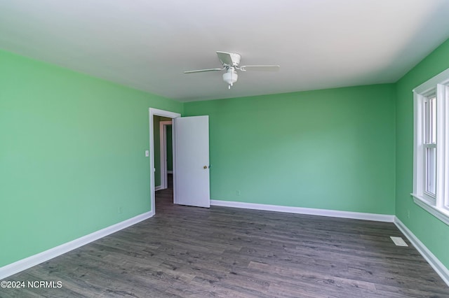 spare room with ceiling fan and dark hardwood / wood-style floors