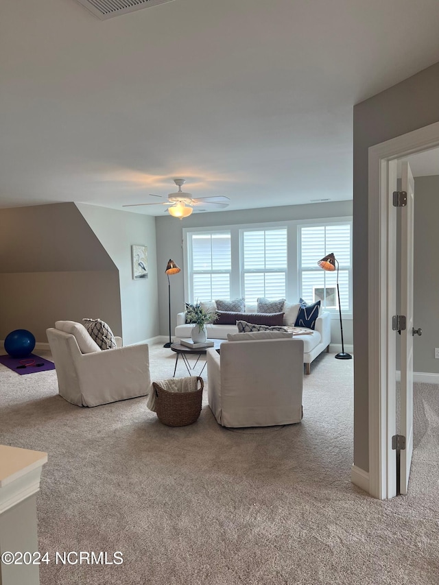 living room with carpet, ceiling fan, and baseboards