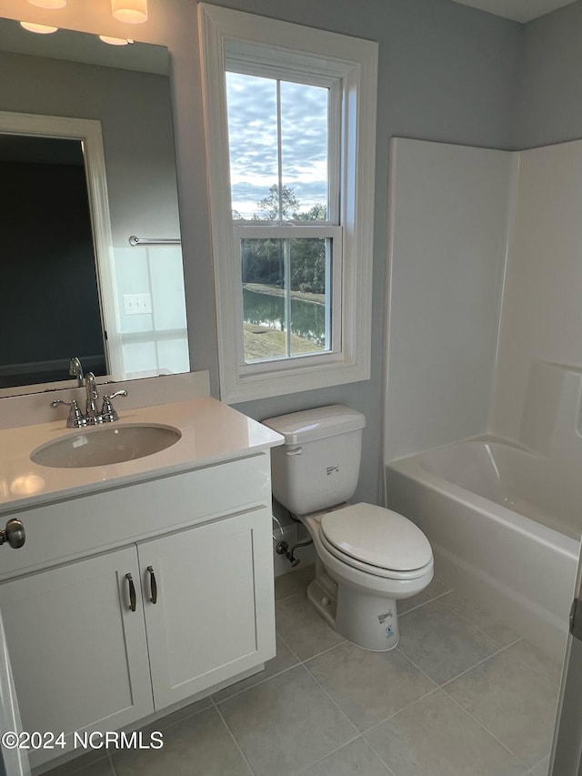 full bath featuring toilet, a tub, tile patterned flooring, and vanity