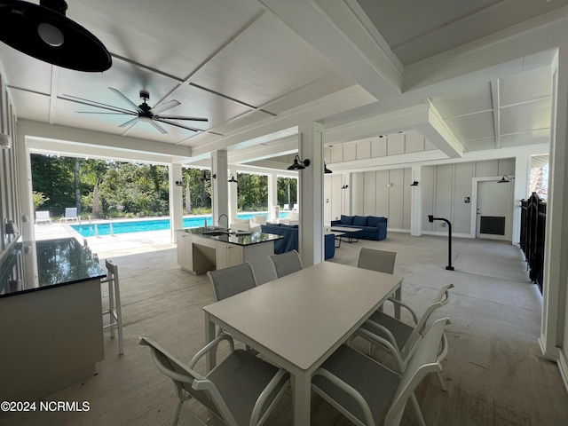 view of patio featuring ceiling fan, outdoor dining space, and an outdoor pool