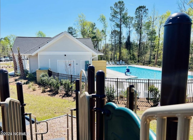 community pool with fence and a patio