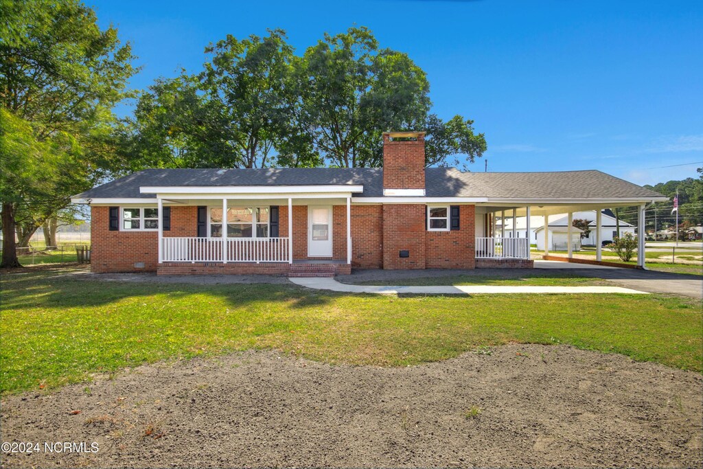 back of house featuring a lawn and a porch