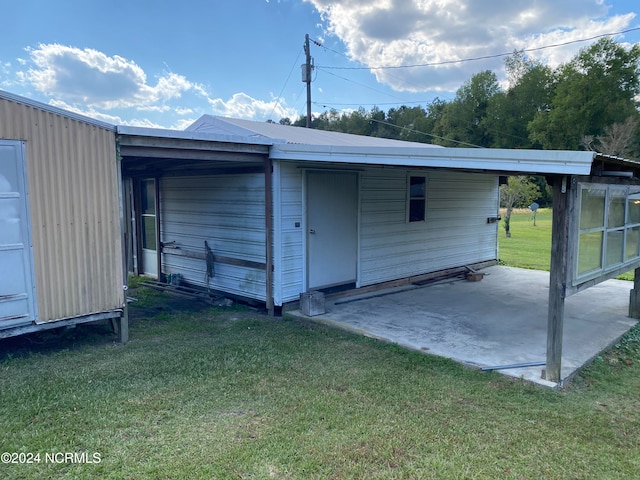 view of outbuilding featuring a lawn