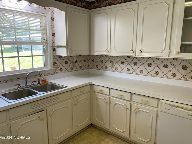 kitchen with backsplash, dishwasher, and sink