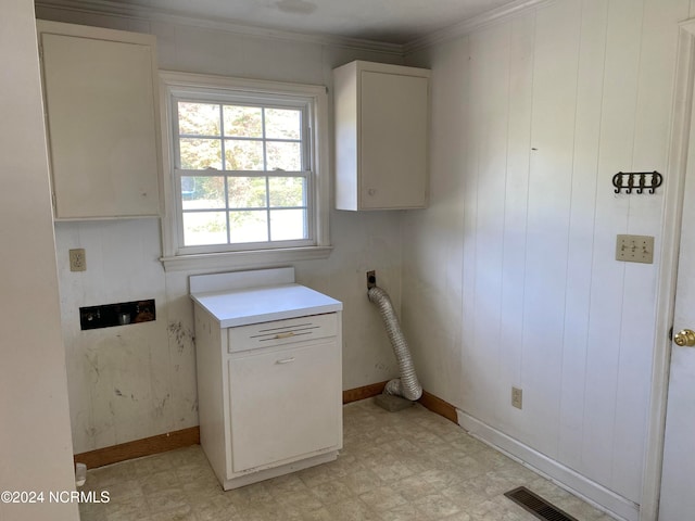 laundry room featuring cabinets, electric dryer hookup, and crown molding