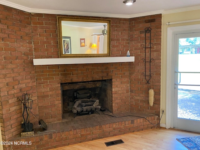 details with a fireplace, wood-type flooring, and crown molding