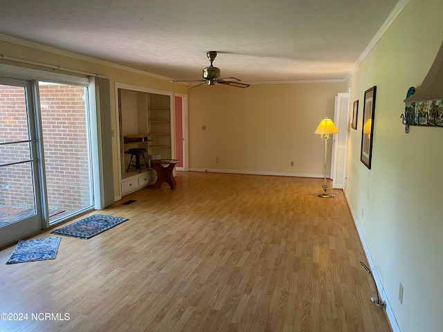 interior space with crown molding, ceiling fan, light hardwood / wood-style floors, and a textured ceiling