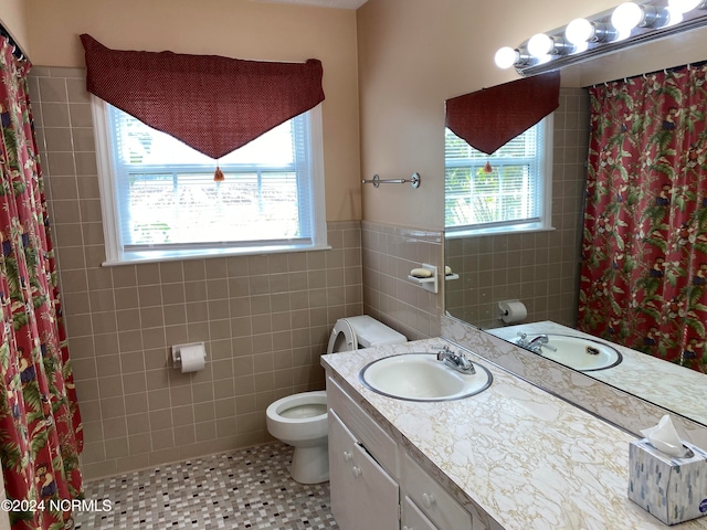 bathroom featuring vanity, tile patterned floors, a shower with curtain, toilet, and tile walls