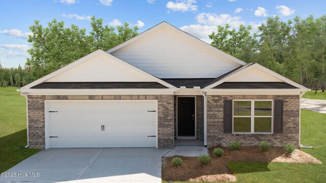 view of front of property with a front lawn and a garage