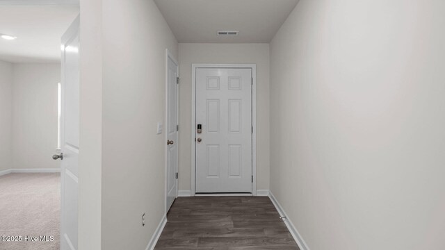 hallway with wood-type flooring