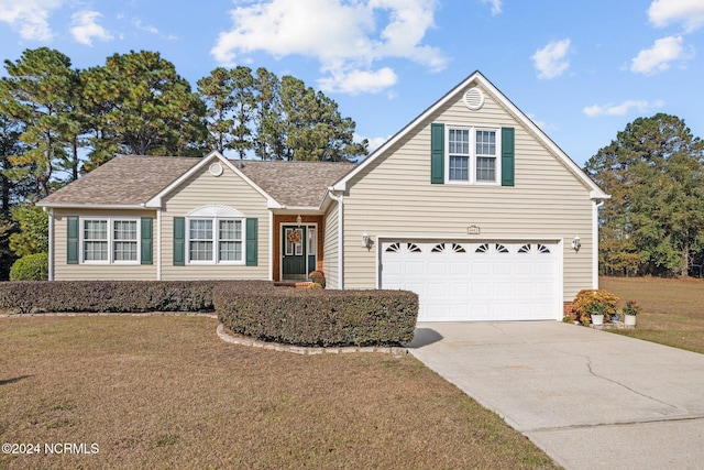 view of front property featuring a garage and a front lawn