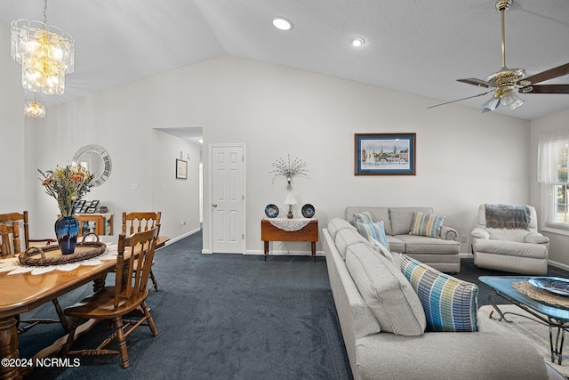 living room featuring dark colored carpet, ceiling fan with notable chandelier, and vaulted ceiling