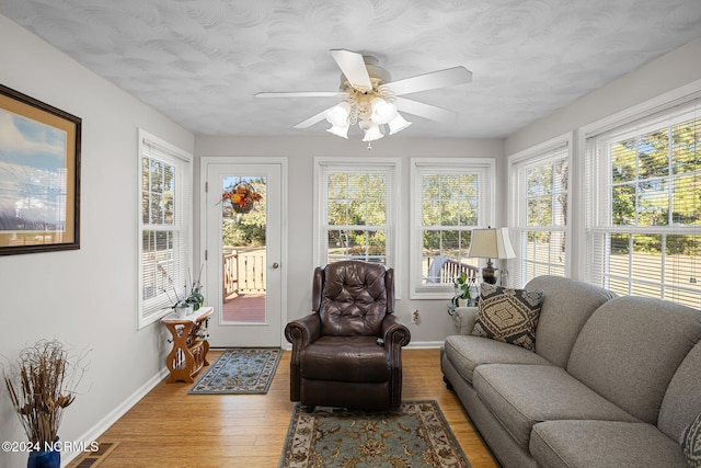 sunroom / solarium featuring ceiling fan