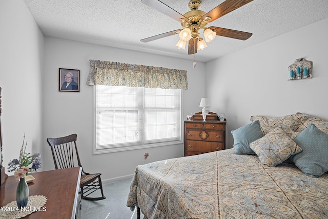 bedroom with carpet, ceiling fan, and a textured ceiling