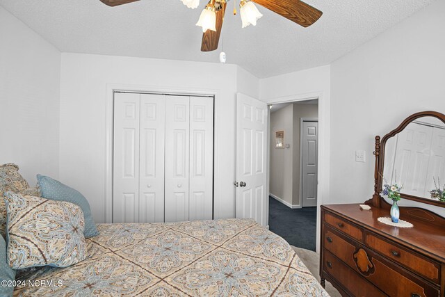 carpeted bedroom with a textured ceiling, a closet, and ceiling fan