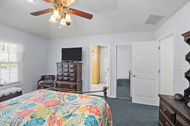 bedroom with carpet, ceiling fan, a textured ceiling, and vaulted ceiling